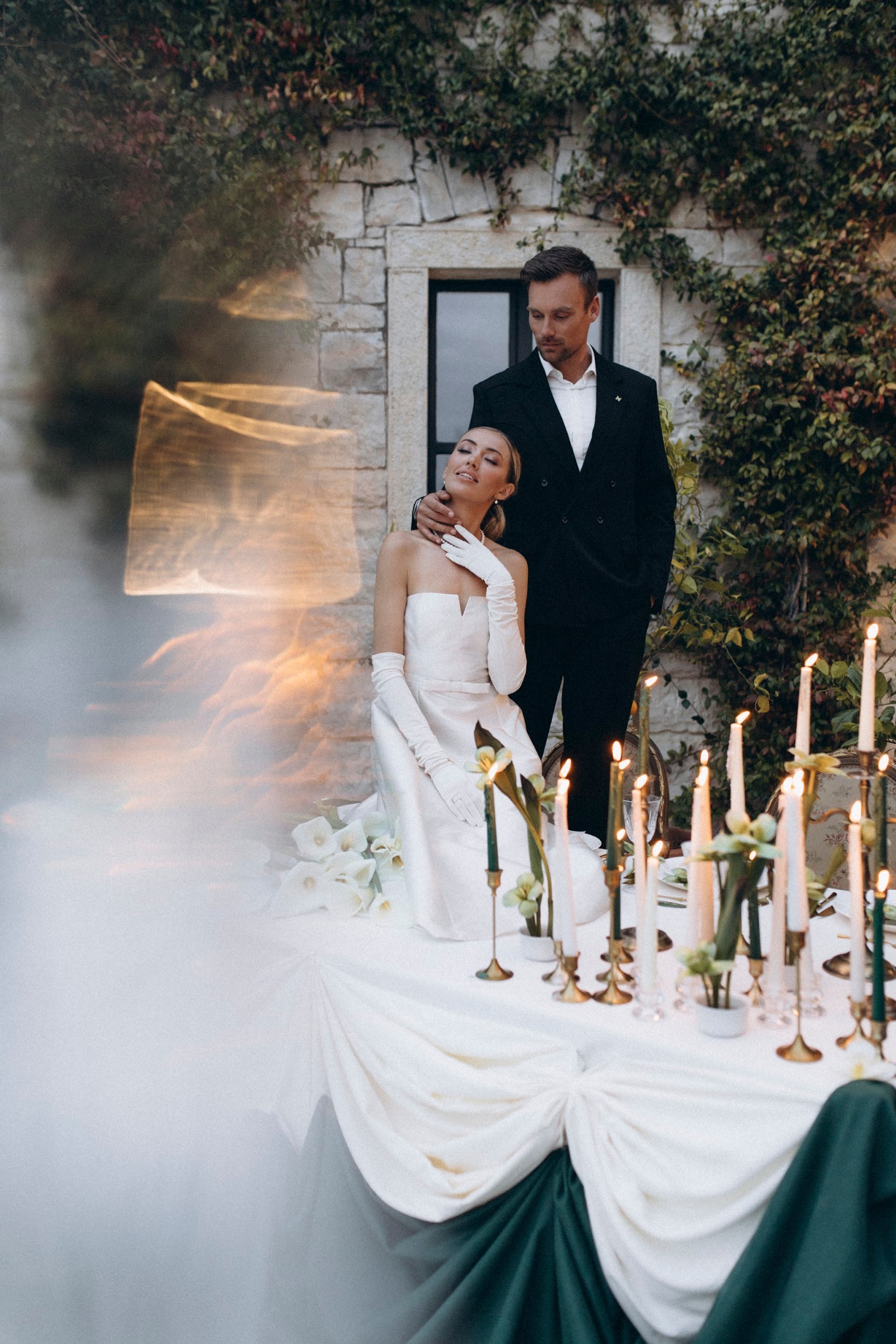 Flottie flower decor, wedding, and organisation at Borgo Lapis in Croatia: elegant table settings featuring embossed white plates, gold cutlery, and a unique green flower detail