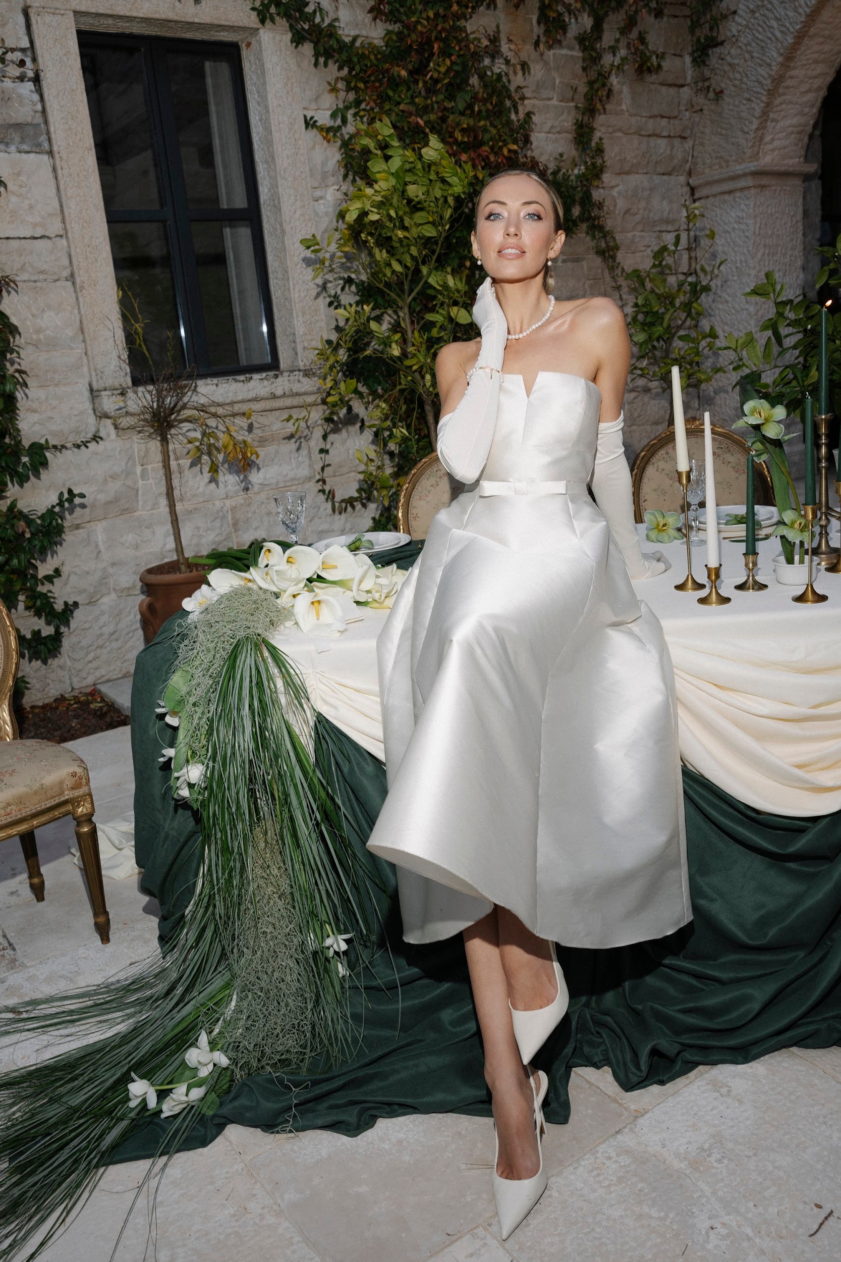 Flottie flower decor, wedding, and organisation at Borgo Lapis in Croatia: elegant table settings featuring embossed white plates, gold cutlery, and a unique green flower detail