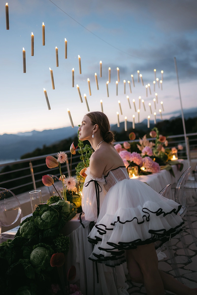 Flottie The Cabbage Affair wedding decor and organisation: elegant outdoor wedding banquet table styled with delicate pink hydrangeas, cabbage leaves, and a magical array of floating candles suspended from above