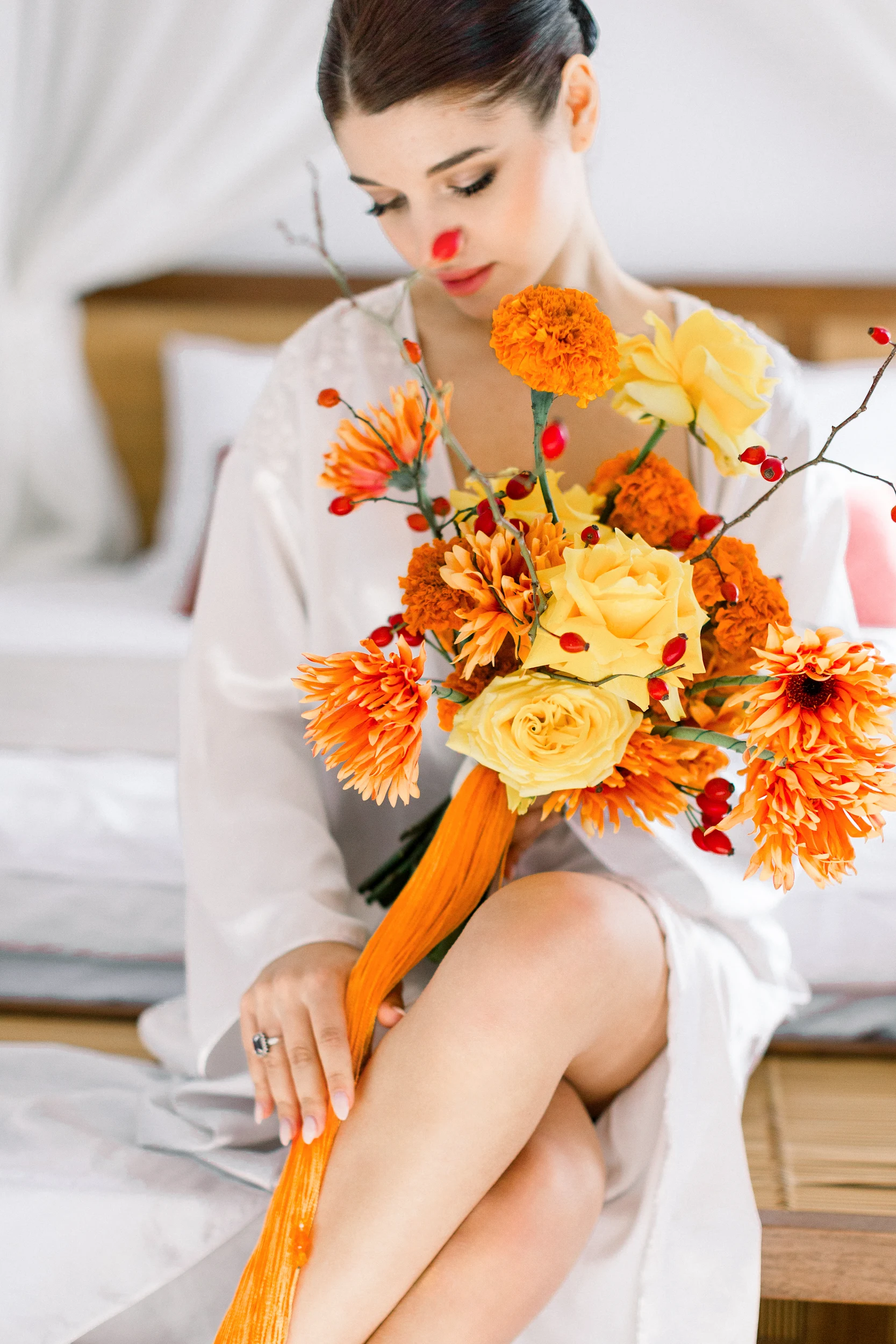 Flottie wedding floral design for "Citrus Muse": close-up of bright orange and yellow bridal bouquet and decor organisation at Villa Mona Lisa in Montenegro