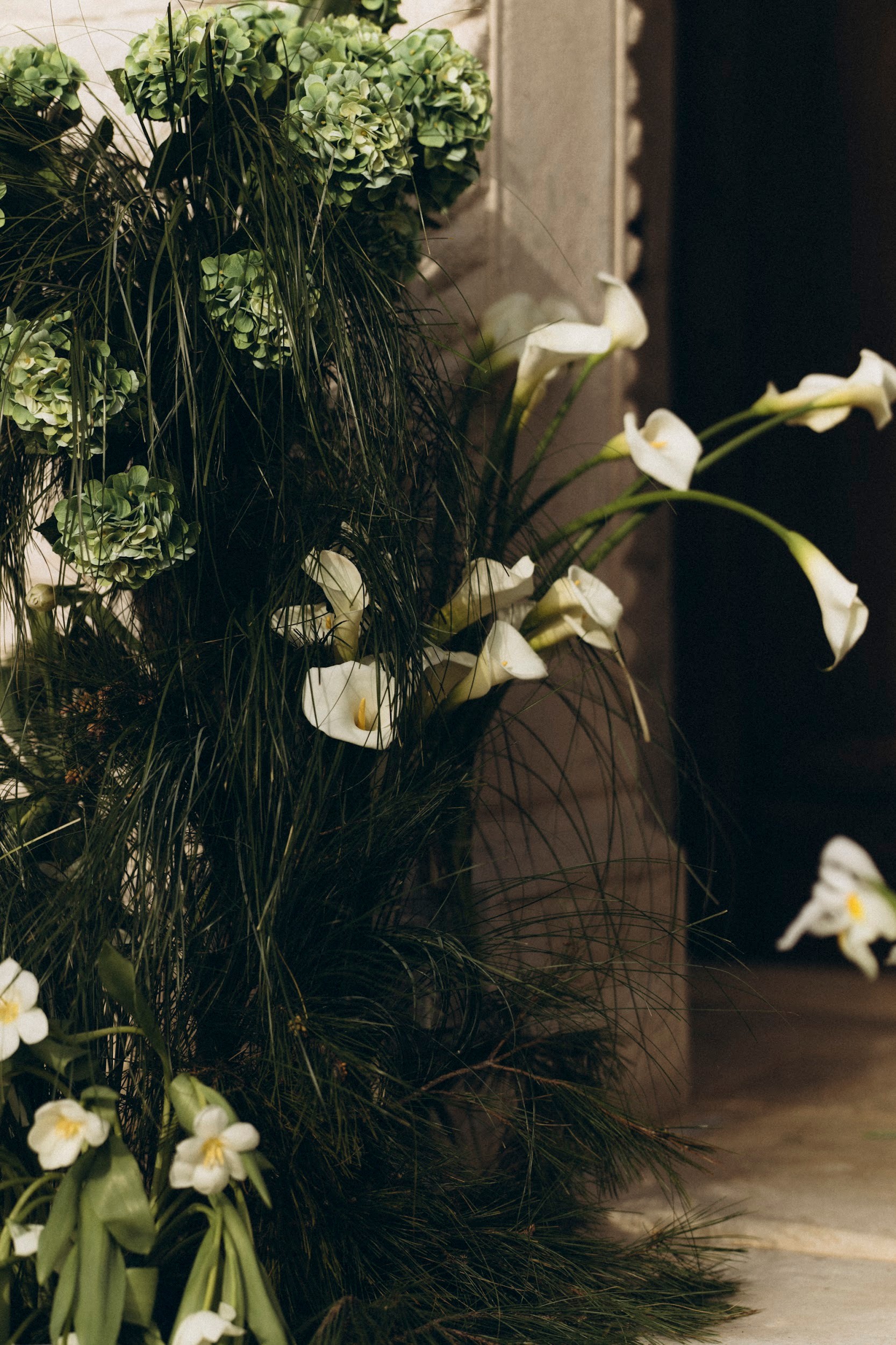 Flottie flower decor, wedding, and organisation at Borgo Lapis in Croatia: detailed shot of elegant white iris and green botanical floral arrangements