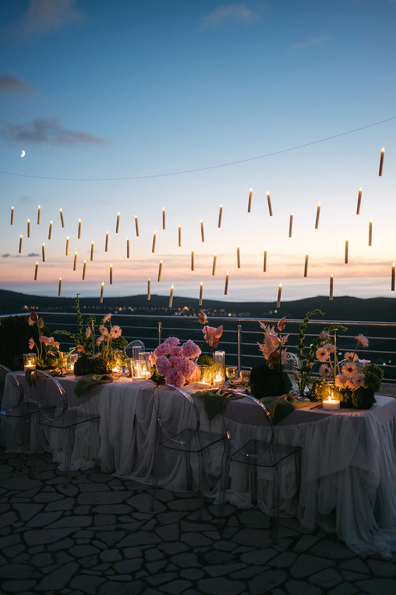 Flottie The Cabbage Affair wedding decor and organisation: elegant outdoor wedding banquet table styled with delicate pink hydrangeas, cabbage leaves, and a magical array of floating candles suspended from above