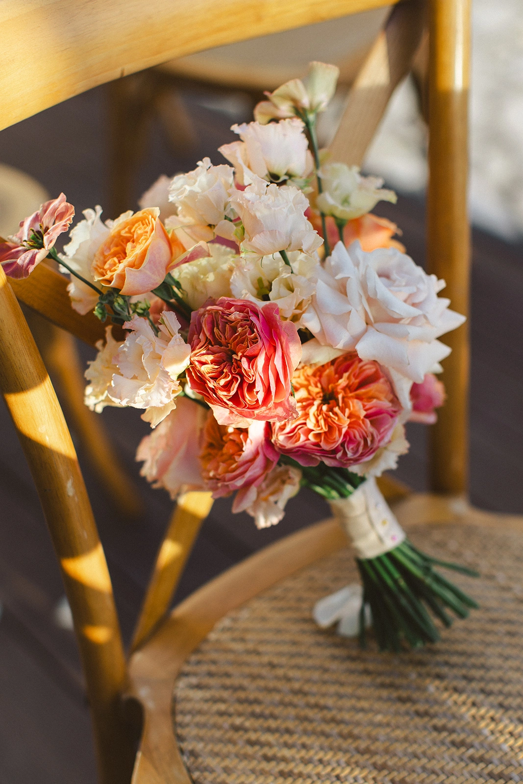 Flottie Peach Haze wedding decor and organisation: portrait of a bride in a lace gown holding a custom peach and pastel bridal bouquet