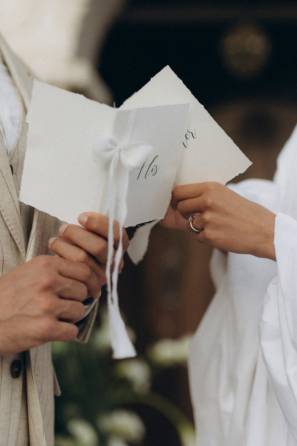 Flottie flower decor, wedding, and organisation at Borgo Lapis in Croatia: close-up of bride and groom showing wedding rings alongside a bespoke floral bouquet