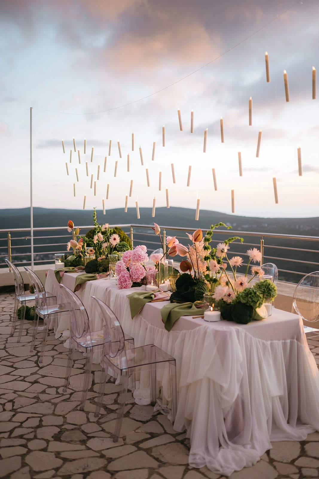 Flottie The Cabbage Affair wedding decor and organisation: elegant outdoor wedding banquet table styled with delicate pink hydrangeas, cabbage leaves, and a magical array of floating candles suspended from above
