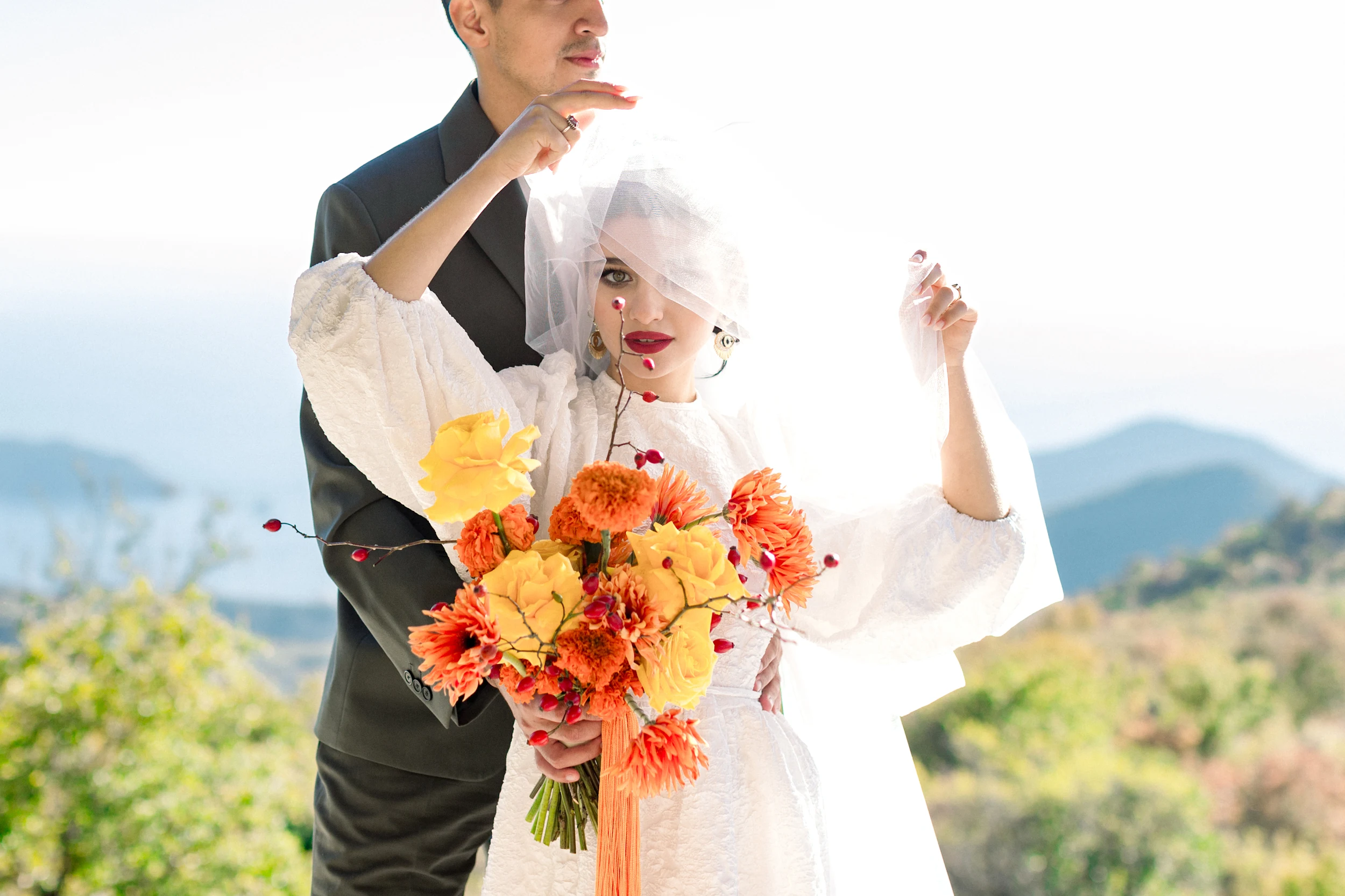 Flottie wedding floral design for "Citrus Muse": close-up of bright orange and yellow bridal bouquet and decor organisation at Villa Mona Lisa in Montenegro